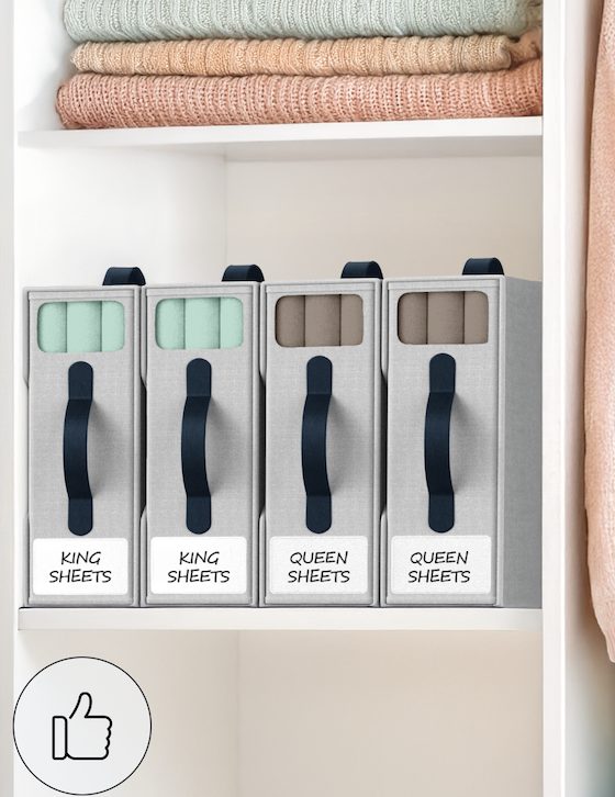 Organized linen closet with NeatlyThere bed sheet organizers labeled King Sheets and Queen Sheets