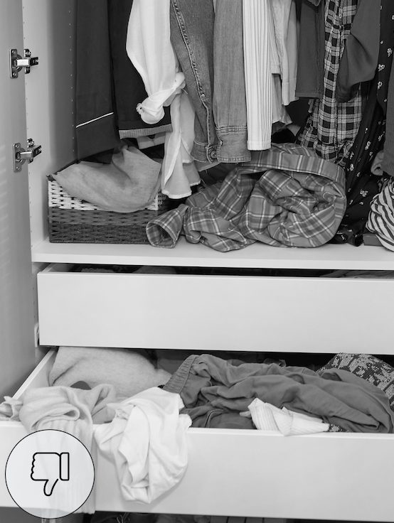 Cluttered linen closet with unfolded bed sheets piled on shelves