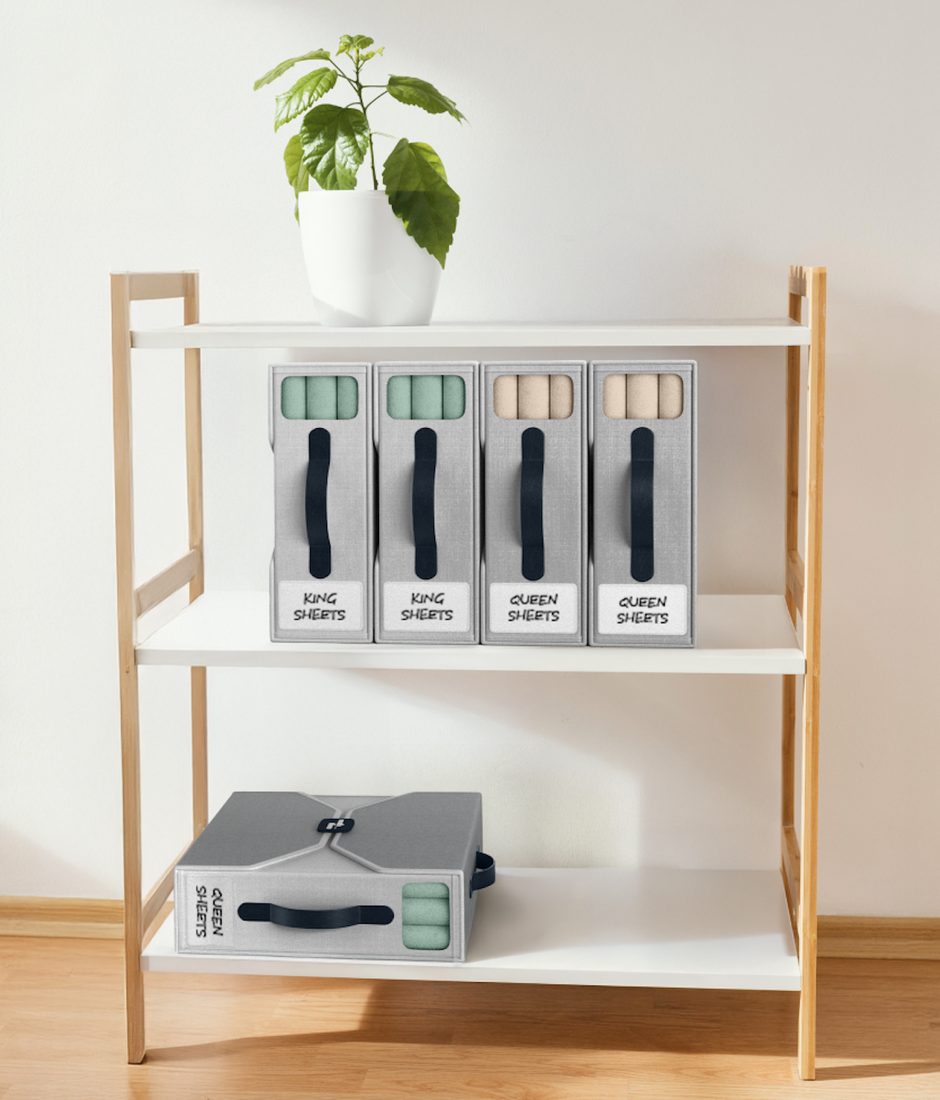 Grey bed sheet organizers arranged on open shelving with King and Queen labels